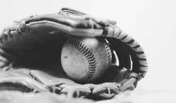 Closeup of baseball glove clutching baseball from Larry Brown Sports