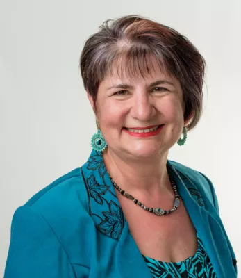 woman-with-asymmetrical-hairstyle-in-teal-jacket