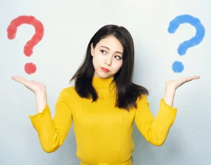 woman holding arms like scales with question marks over each